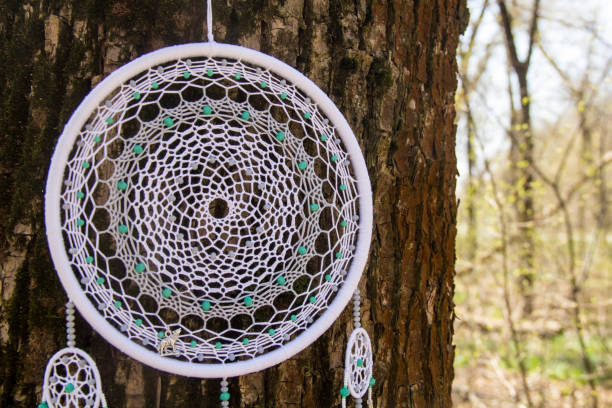 istock Handmade dream catcher with feathers threads and beads rope hanging 957532776