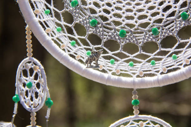 istock Handmade dream catcher with feathers threads and beads rope hanging 957532798