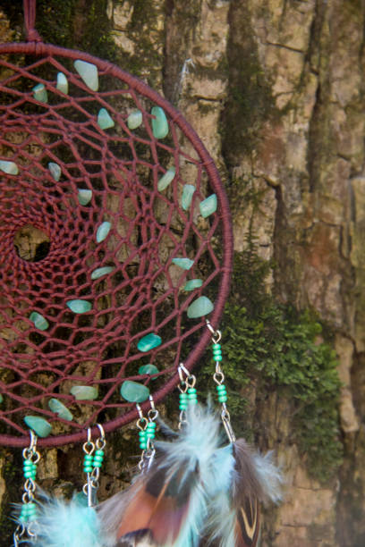 istock Handmade dream catcher with feathers threads and beads rope hanging 957532848