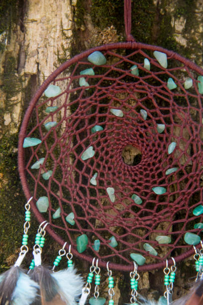 istock Handmade dream catcher with feathers threads and beads rope hanging 957532870