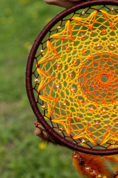 istock Handmade dream catcher with feathers threads and beads rope hanging 957535320