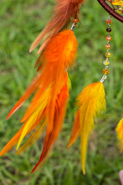 istock Handmade dream catcher with feathers threads and beads rope hanging 957535328