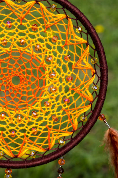 istock Handmade dream catcher with feathers threads and beads rope hanging 957535338