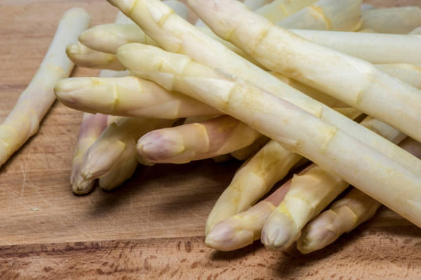 istock Asparagus on wood background 957536822