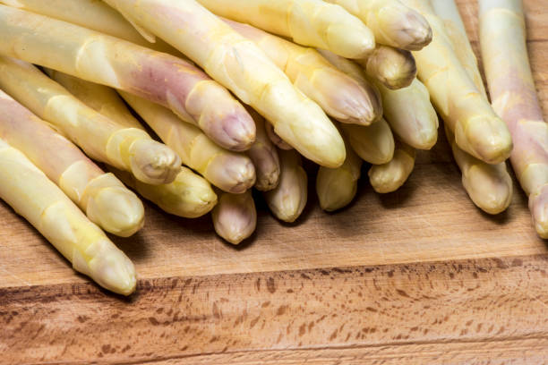 istock Asparagus on wood background 957539476