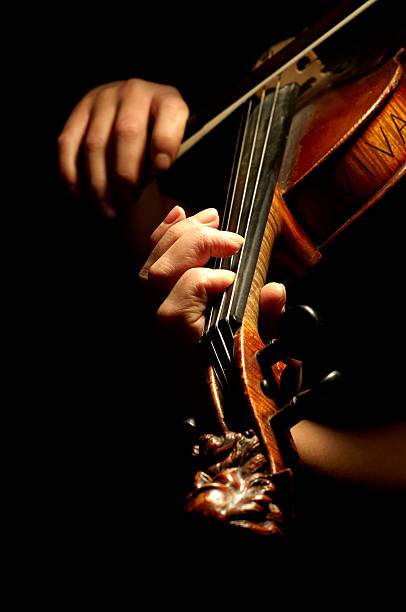 istock A musician playing the violin in the dark 95754924