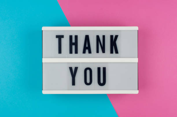 istock Thank you - text on a display lightbox on blue and pink bright background. 957551732