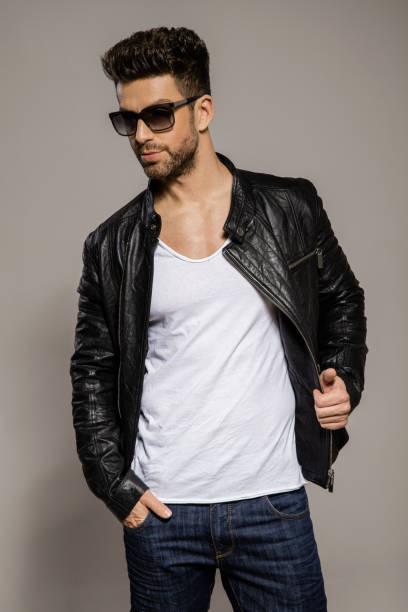 istock Handsome man wear leather jacket and posing in studio 957554166