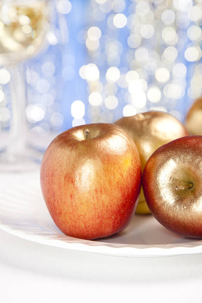 istock festive golden apples  on glitter red background 95756069