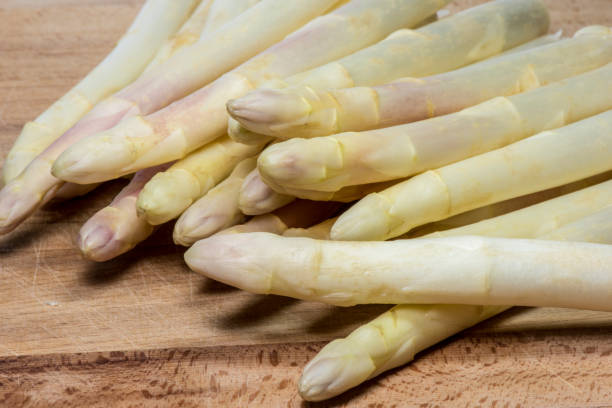 istock Asparagus on wood background 957563886