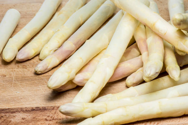 istock Asparagus on wood background 957566380