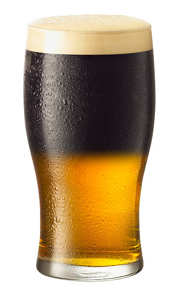 A pint glass of beer with a foam head stock photo