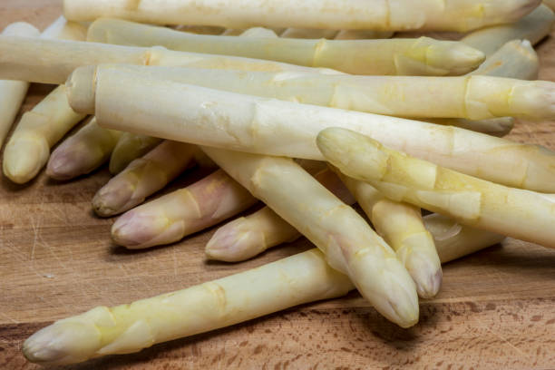 istock Asparagus on wood background 957570060