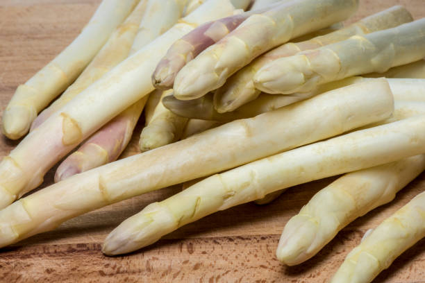 istock Asparagus on wood background 957570566