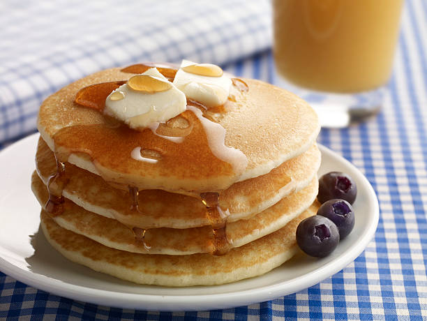 Close-up of a plate of pancakes with butter and syrup stock photo