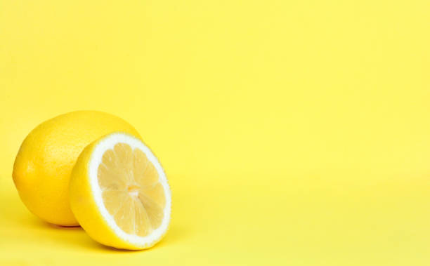 Ripe whole lemon citrus fruit with lemon fruit half stock photo