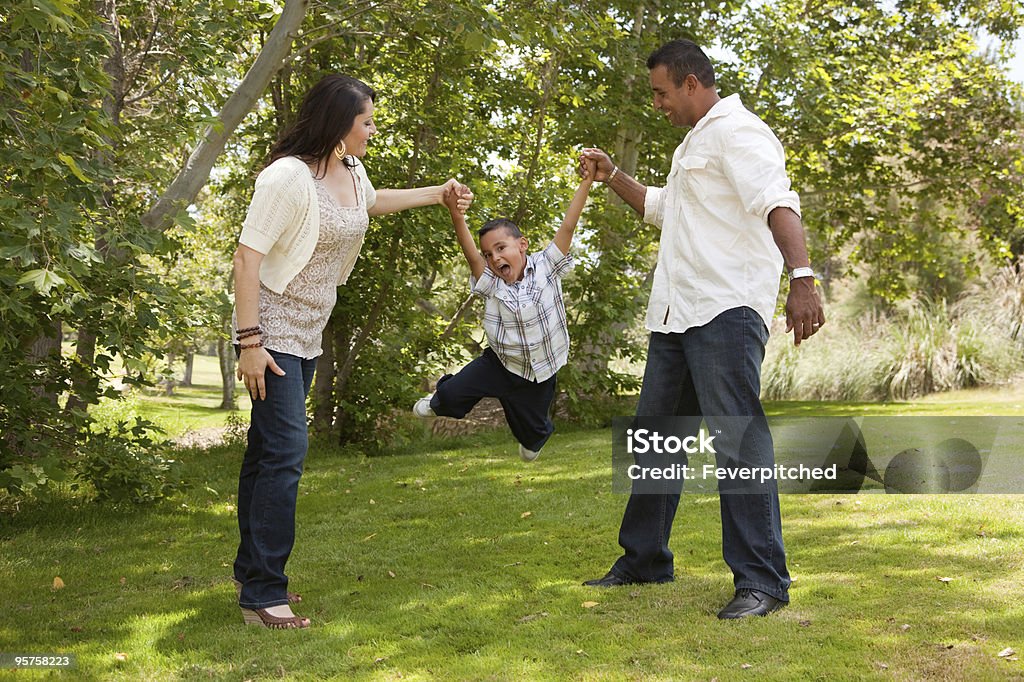 Young Hispanic Family Having Fun in the Park  Family Stock Photo