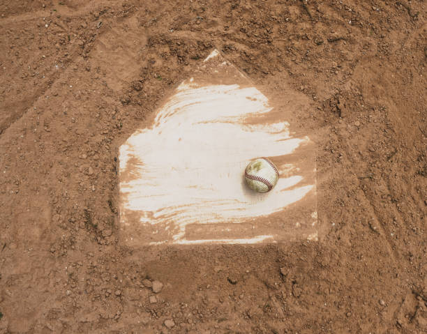 Baseball on field Baseball laying with homeplate on dirt field for game. home plate stock pictures, royalty-free photos & images