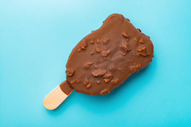 istock chocolate outer ice cream starts melting on a blue background 957587438