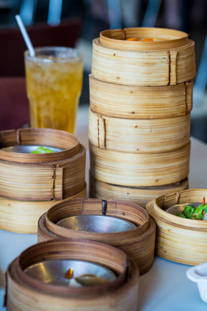 istock Chinese appetizer, Dimsum, streamed cuisine on bamboo basket container 957588188