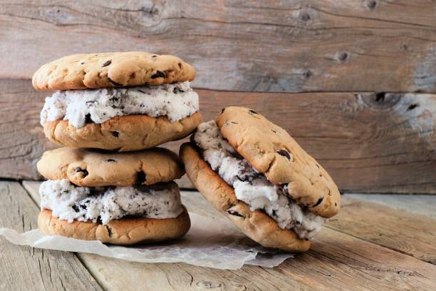 istock Chocolate chip cookie ice cream sandwiches against rustic wood 957590908