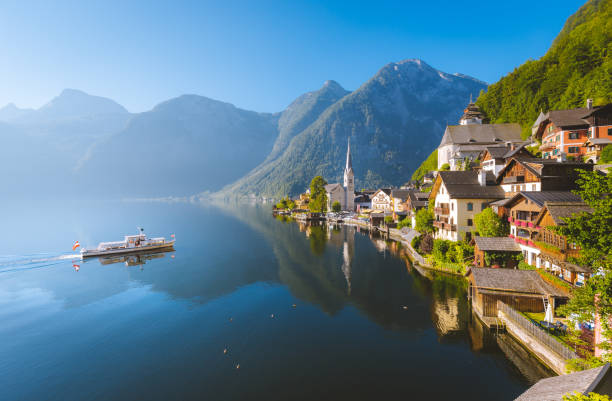 istock Classic view of Hallstatt with ship in summer, Austria 957592924