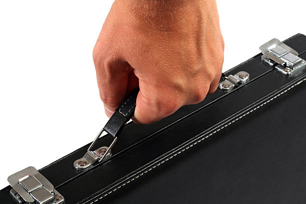 istock Hand with a black suitcase. Isolated on white background 95759343