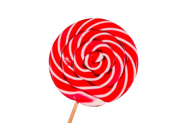 Red and white spiral lollipop candy as background.