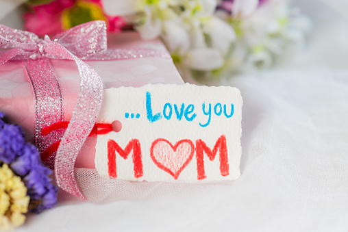 Happy Mothers Day Concept Pink Gift Box With Purple Flower Paper Tag With Love  Mom Text On White Cheesecloth Background Stock Photo - Download Image Now -  iStock