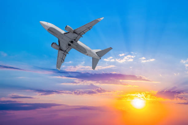 istock Airplane takes off against  setting sun background. 957597684