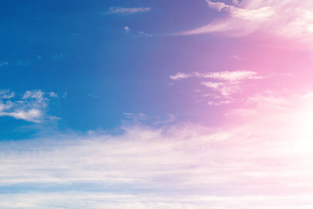 istock clouds against a blue sky with rays of the sun 957604758