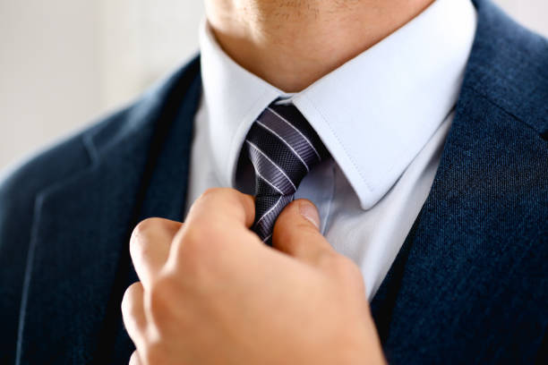 istock Male arm in blue suit set tie closeup 957604982
