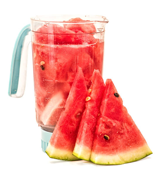 istock watermelon and mineral water in a blender. making a smoothie in a blender. blender with watermelon and watermelon slices isolated on white background 957609670