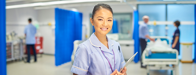 a female nurse smiling to camera