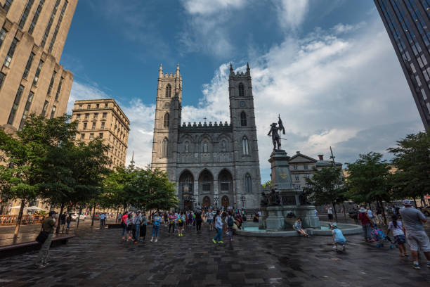 Palace d'Armes and Notre Dame Basilica in Montreal August 4, 2017 - Montreal, Canada: Tourists exploring the Palace d'Armes and Basilique Notre Dame de Montreal. place darmes montreal stock pictures, royalty-free photos & images