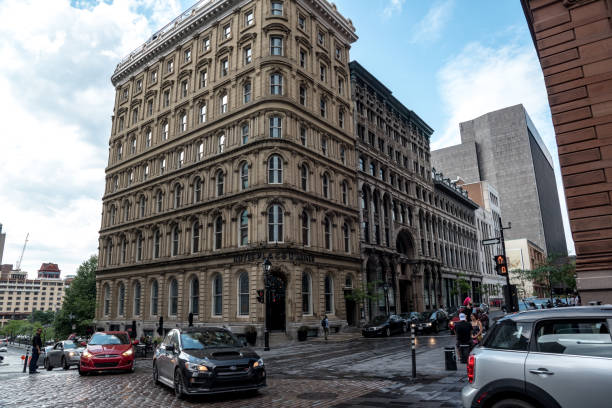 Palace d'Armes and Notre Dame Basilica in Montreal August 4, 2017 - Montreal, Canada: Tourists exploring the Palace d'Armes and Basilique Notre Dame de Montreal. place darmes montreal stock pictures, royalty-free photos & images