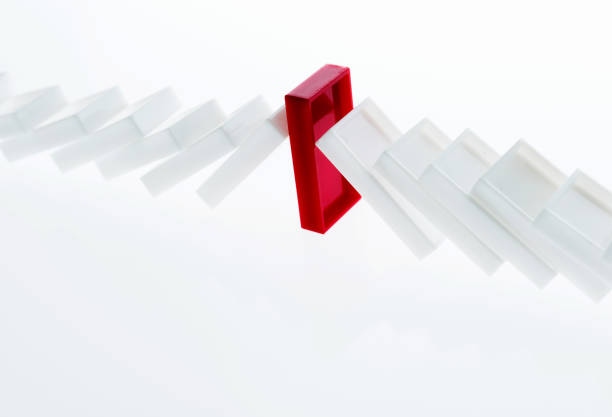 istock A row of white dominos falling down 957612816