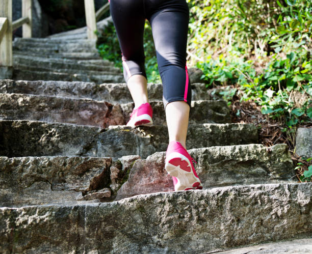 istock Woman feet walking on the steps 957613802