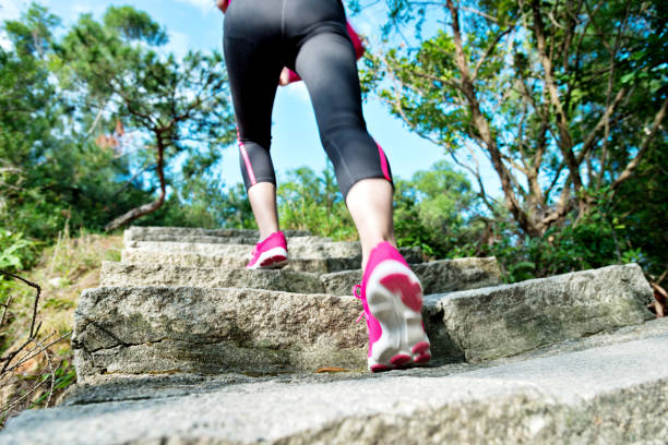 istock Woman feet walking on the steps 957613818