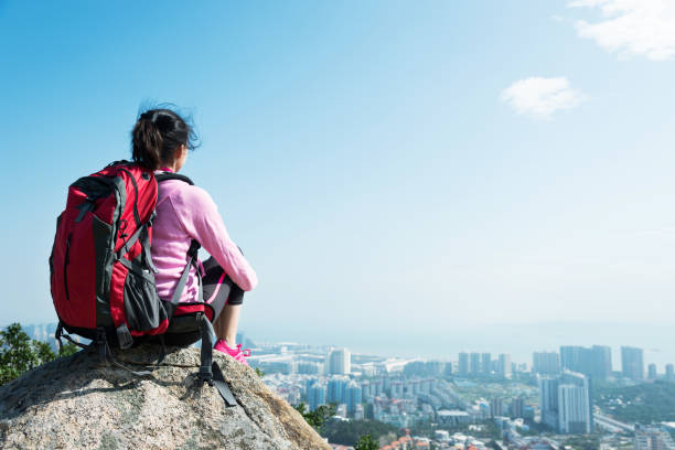 istock Woman backpacker enjoy the view on mountain peak 957616606