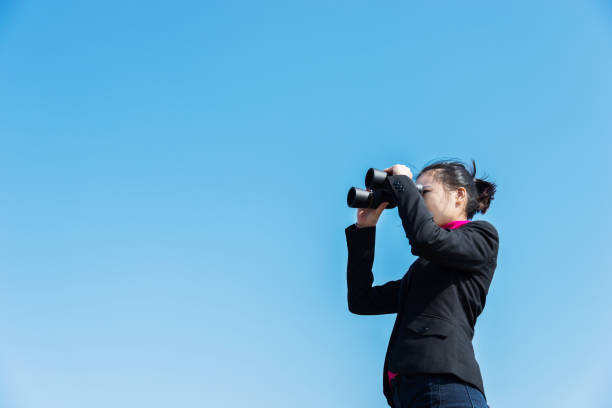 istock Businesswoman looking scenery with binocular 957617390