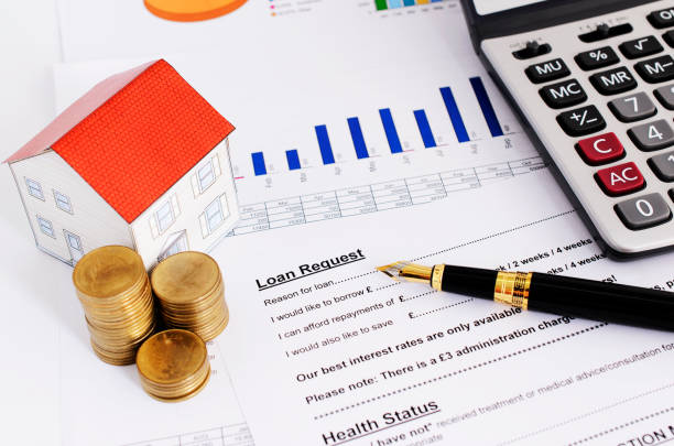istock Home loans concept with close up fountain pen and loans request form and coins stack and paper house and calculate 957620128