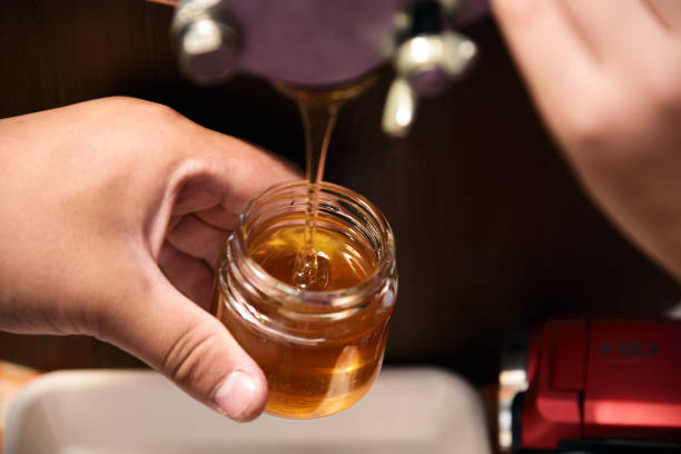 istock bottling the harvested honey 957621112