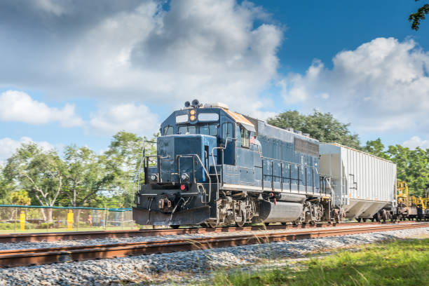 Cargo train Freight train carrying heavy merchandise on a sunny morning. rail car stock pictures, royalty-free photos & images