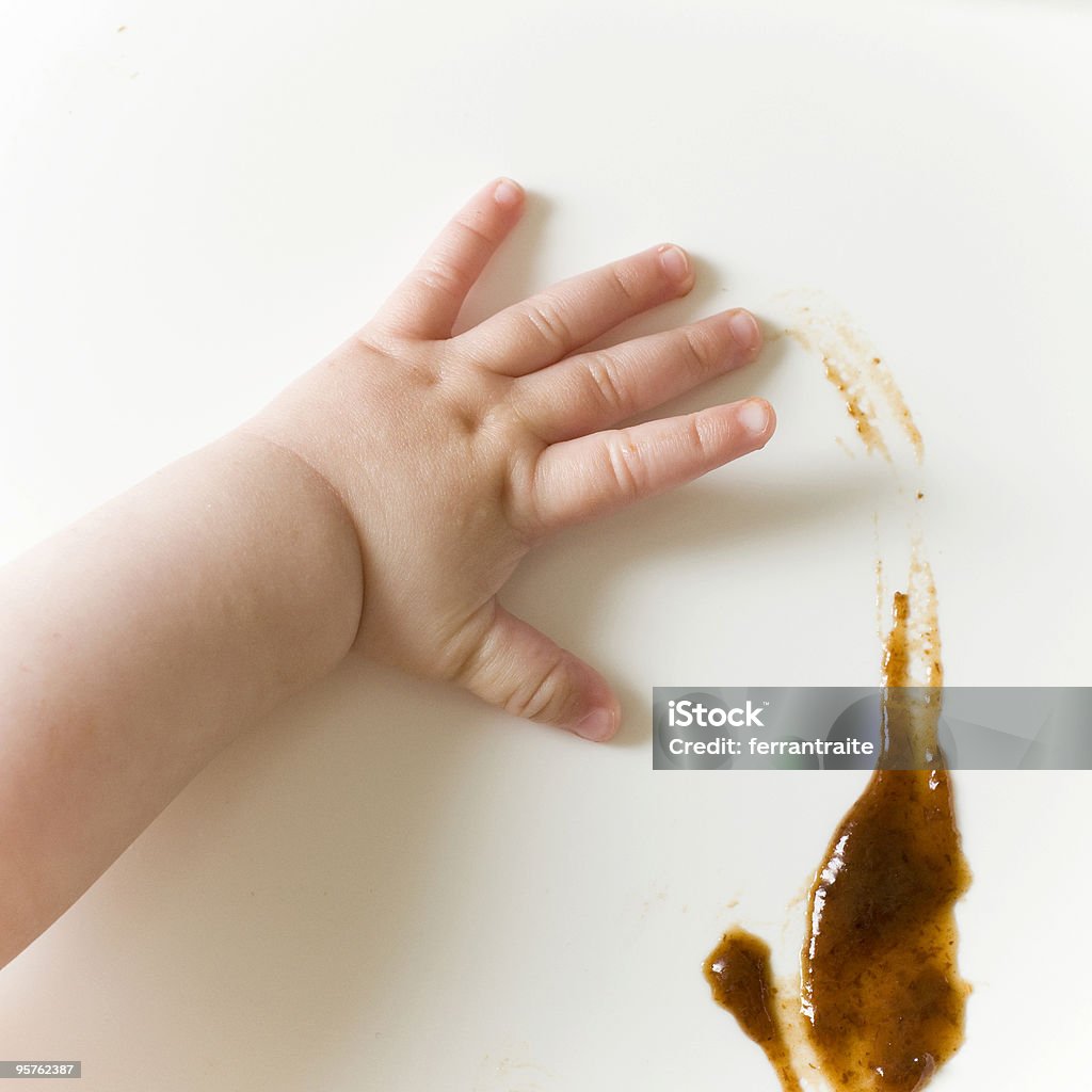 Dirty little princess Baby messing around with her meal. Stained Stock Photo