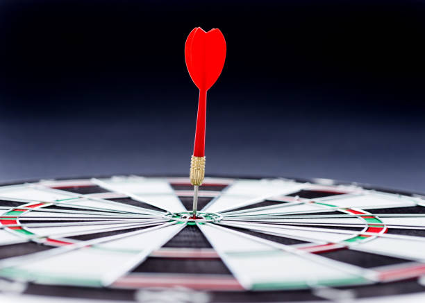 istock Hitting the bulls eye on the black background 957624004