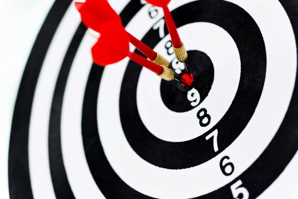 istock Three red darts arrows in the target center 957624076