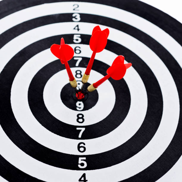 istock Three red darts arrows in the target center 957624128