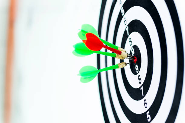 istock Four darts arrows in the target center. 957624182