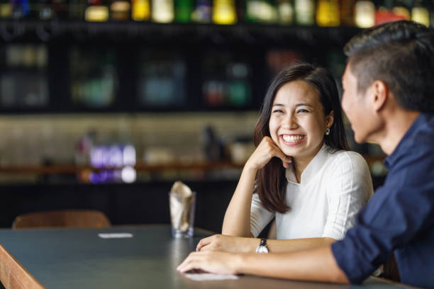 istock Young Asian Couple At A Bar 957624424